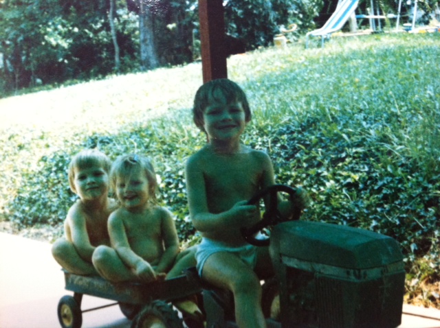 John B. Conger, a brightergy.commercial Solar Developer, driving a tractor at age 2.