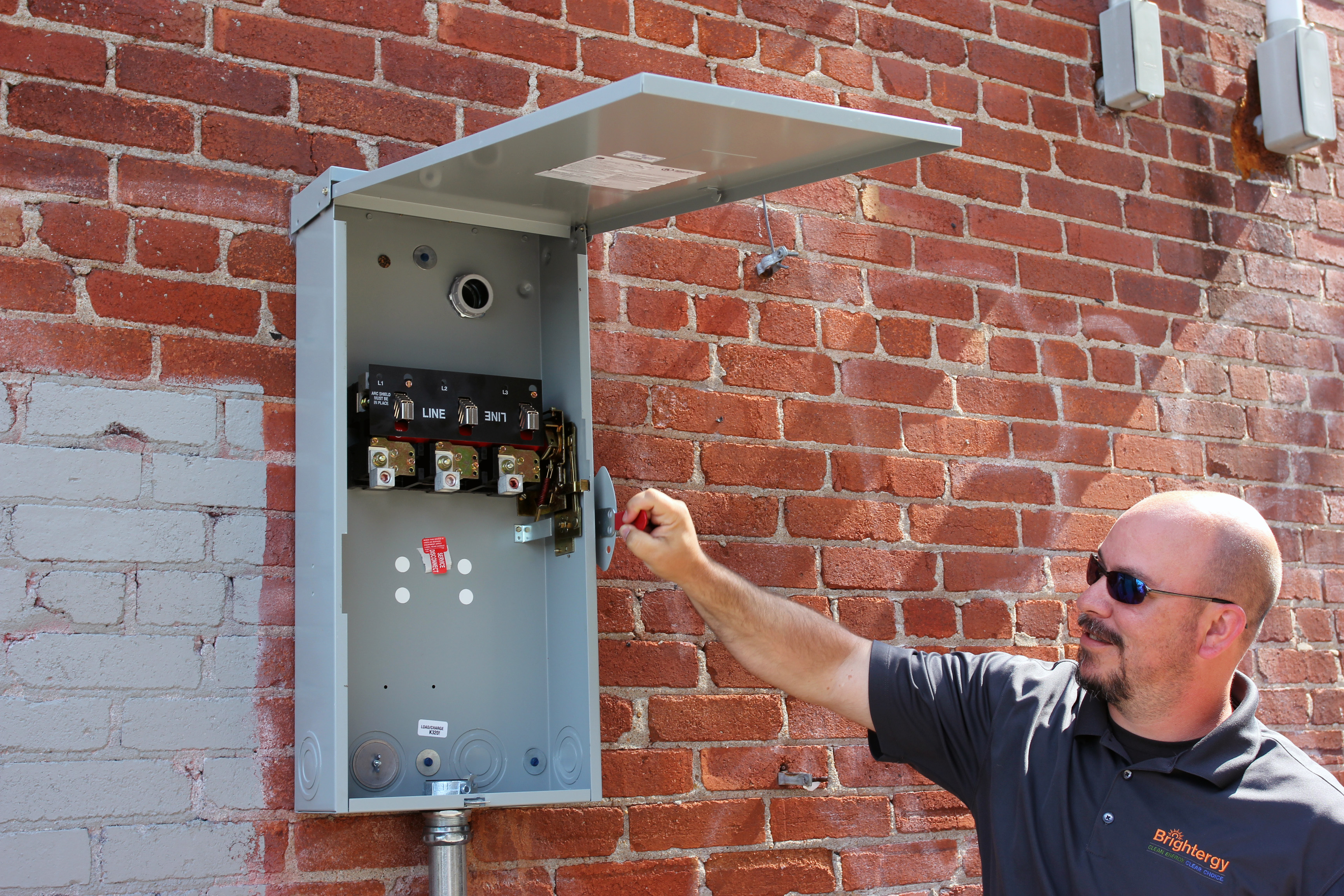 Solar Estimator Jason Mendenhall demonstrates the breaker box's on/off switch. 