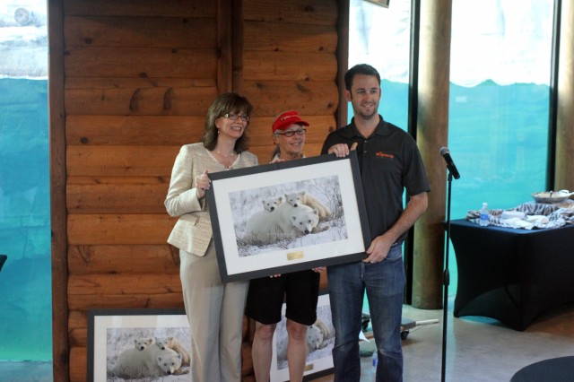 Brightergy principles Susan Brown and Adam Blake accept the Polar Bears International 'Paw of Approval' Award from PBI Founder, Carolyn Buchanan.
