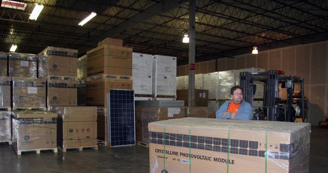 Matt Rogers stands behind a box of solar panels at Brightergy's new 14,000 sq ft warehouse