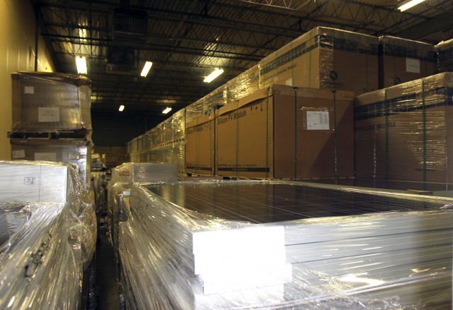 Long rows of solar panel boxes line the Brightergy warehouse